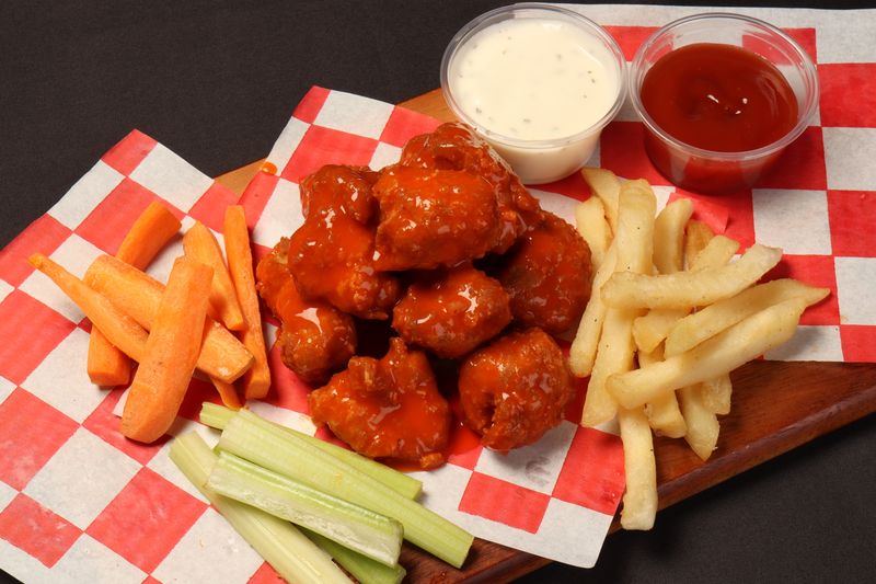 Crispy buffalo wings with celery and blue cheese dipping sauce